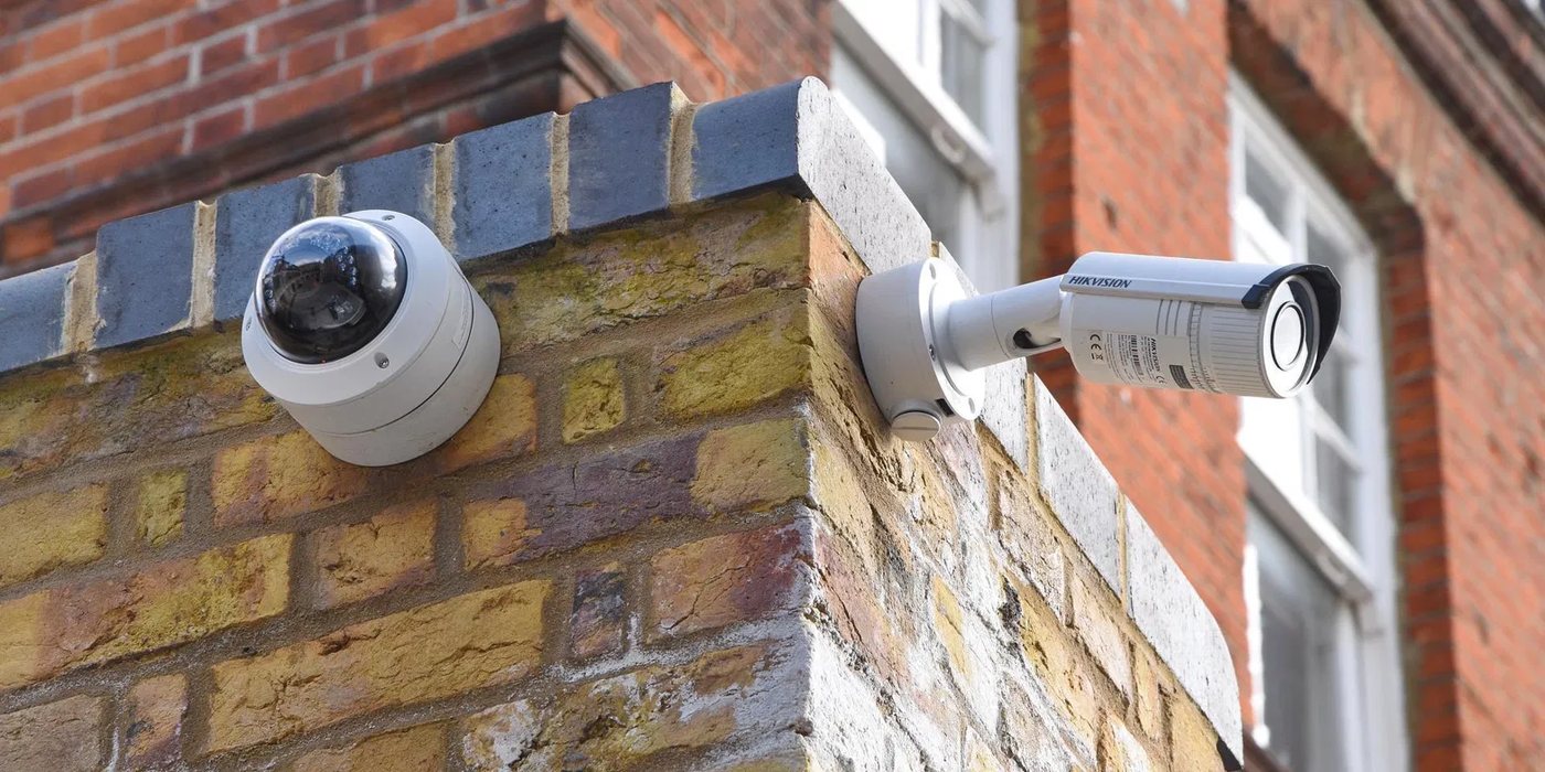 Hikvision dome and bullet CCTV cameras installed on a brick building